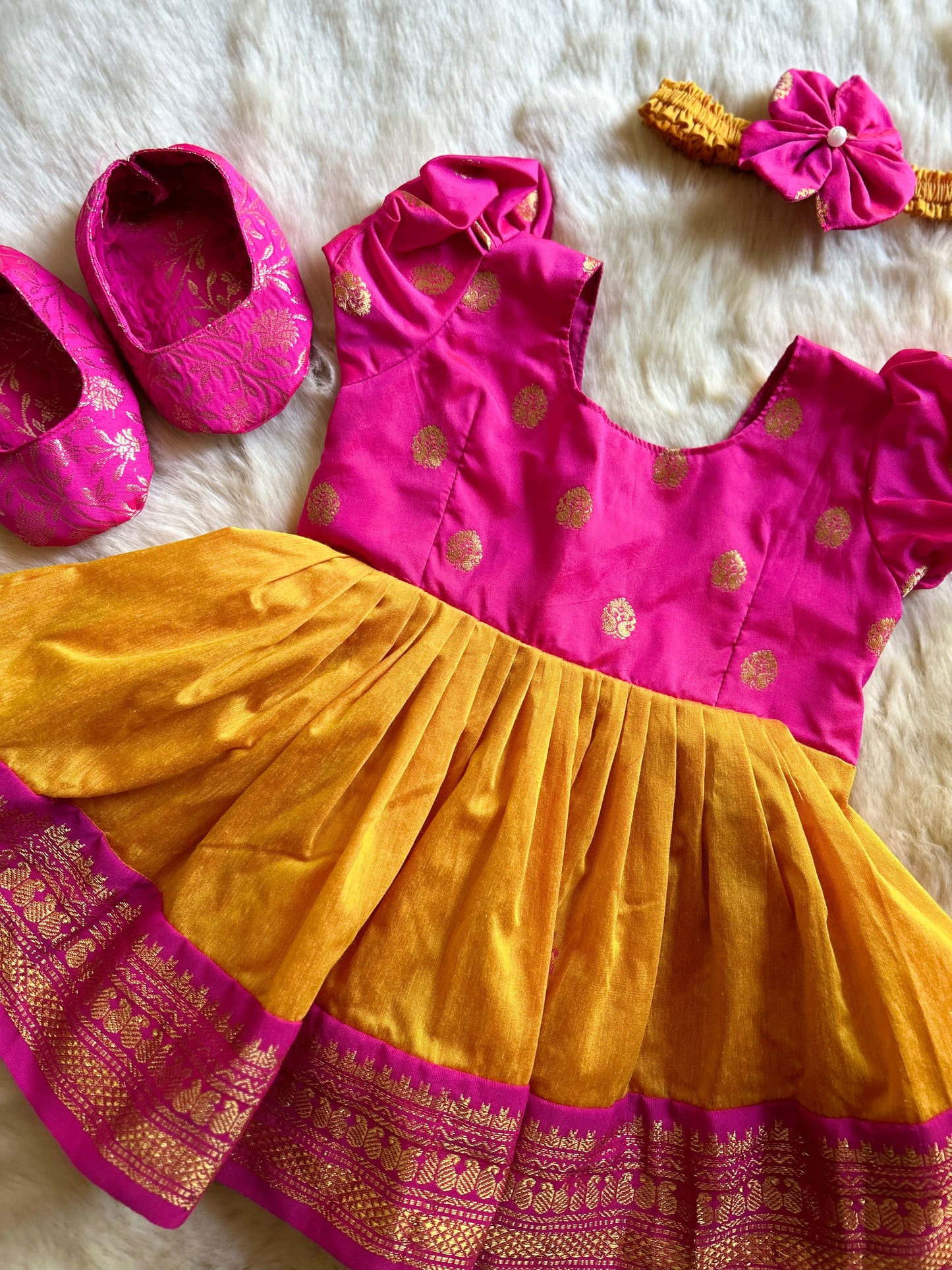 Pink and golden yellow vintage ethnic wear for baby girl with buff sleeves