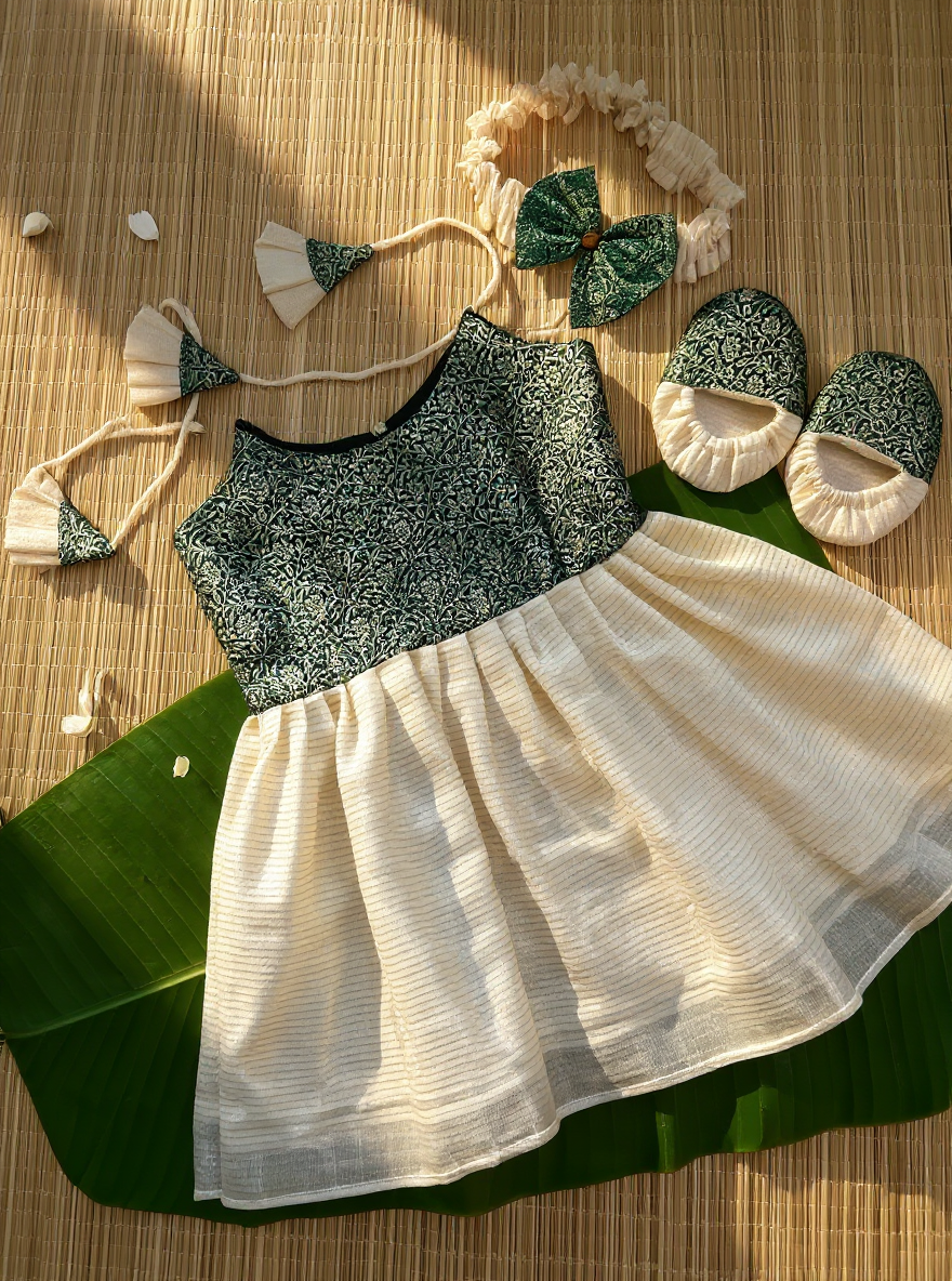 Children's outfit with top, skirt, headband, and shoes on a leaf